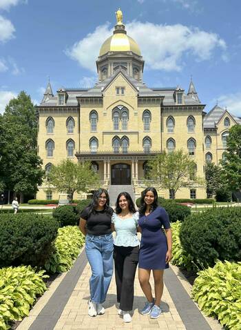 Vamika, Vaishnavi, and Aaddya smile for a photo beneath the Golden Dome.