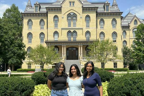 Vamika, Vaishnavi, and Aaddya smile for a photo beneath the Golden Dome.