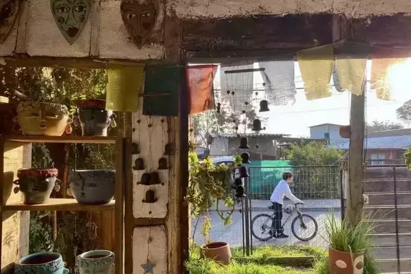 A boy pauses on a bike outside of a pottery shop in Pomaire, Chile. Pomaire is a small town outside of Santiago that is known for its pottery industry. We went on a day trip to Pomaire to take a pottery class and experience the rich culture in this small Chilean town.