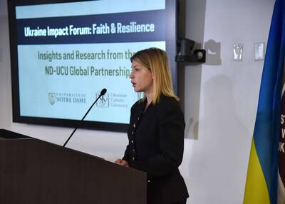 Woman speaks at a podium before a screen displaying "Ukraine Impact Forum: Faith & Resilience" with Notre Dame and UCU logos.